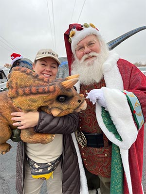 Santa and a friendly dinosaur.